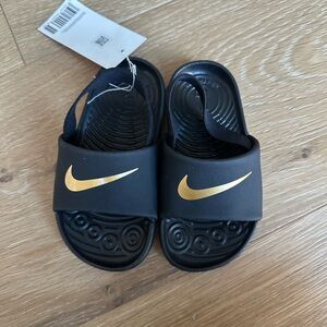Nike Kids Black Sandals with Gold Swoosh